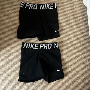Two black Nike Pro spandex/shorts